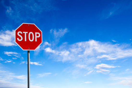 Stop Sign With Blue Sky Background and Copy Space